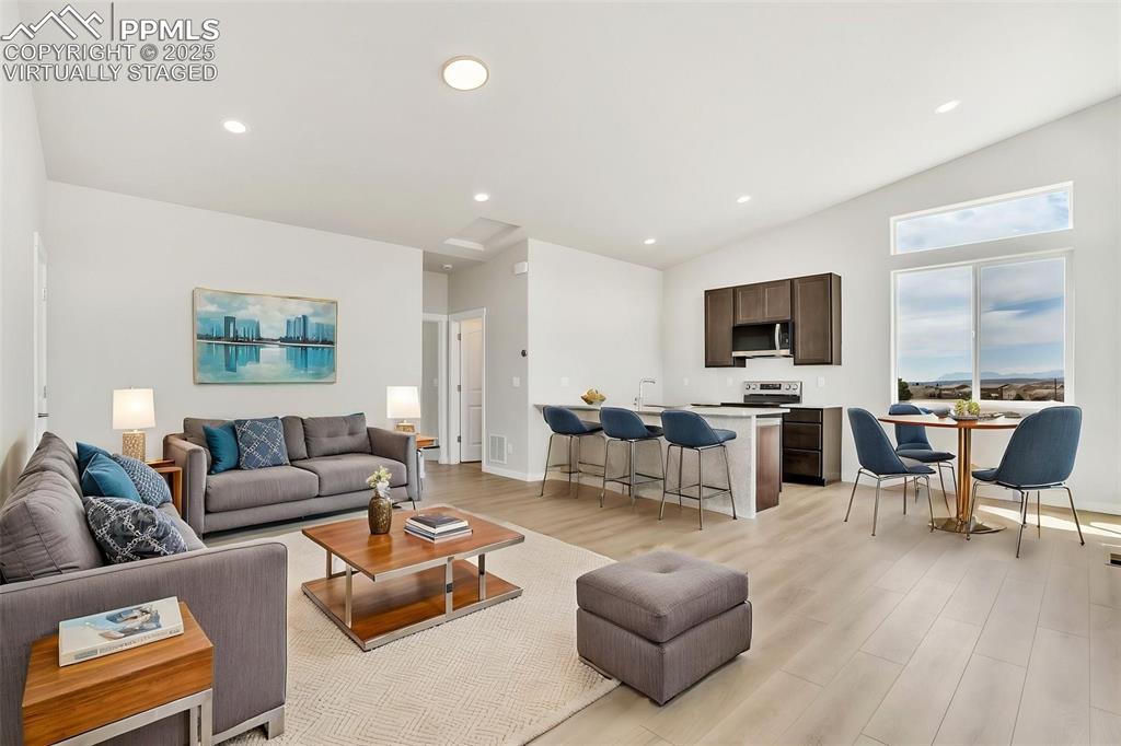 241 Front Street, Unit 101 Monument, CO 80132 - Photo 2 of 29 a living room with furniture and a flat screen tv