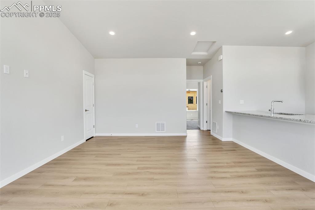 241 Front Street, Unit 101 Monument, CO 80132 - Photo 4 of 29 a view of an empty room with wooden floor