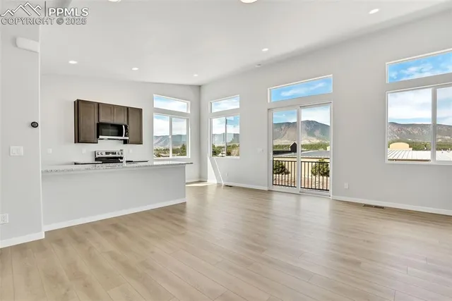 a view of kitchen with cabinets and wooden floor
