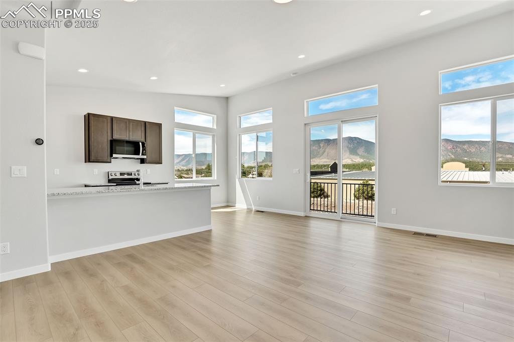 241 Front Street, Unit 101 Monument, CO 80132 - Photo 6 of 29 a view of kitchen with cabinets and wooden floor