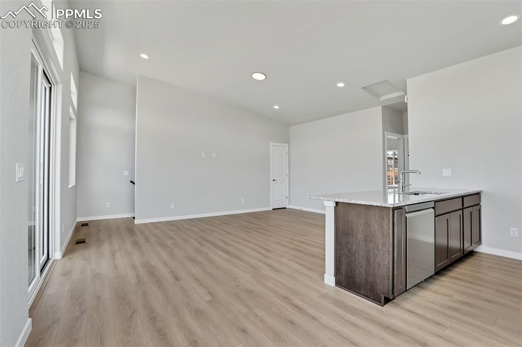 241 Front Street, Unit 101 Monument, CO 80132 - Photo 8 of 29 a view of kitchen with stainless steel appliances granite countertop cabinets and wooden floor
