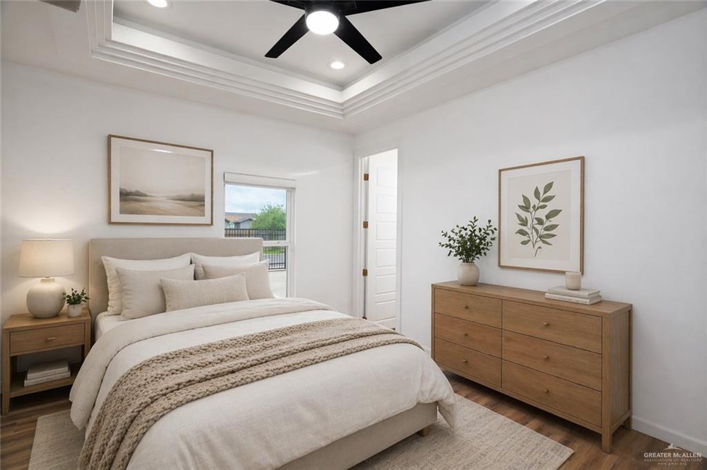3018 Arrow Lane Weslaco, TX 78596 - Photo 11 of 22 a bedroom with a large bed and a chandelier