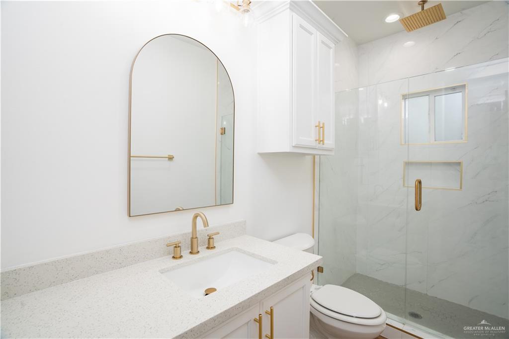 3018 Arrow Lane Weslaco, TX 78596 - Photo 16 of 22 a bathroom with a sink a toilet and shower