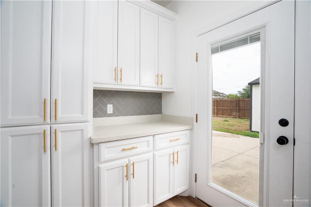 3018 Arrow Lane Weslaco, TX 78596 - Photo 8 of 22 a kitchen with a white cabinets and a sink