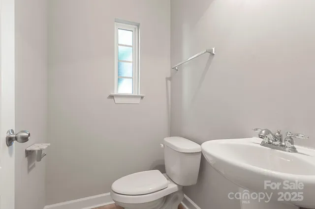 a white toilet sitting next to a white sink