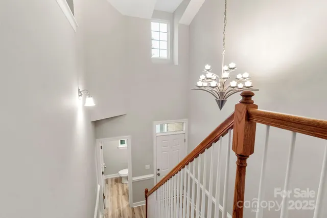 a view of a hallway with chandelier
