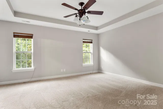 a view of a livingroom with a ceiling fan and window