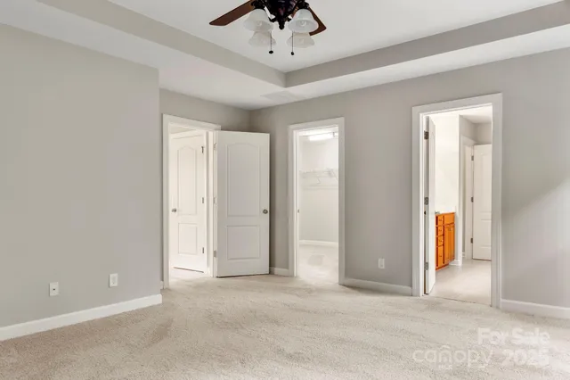 an empty room with fan and entrance