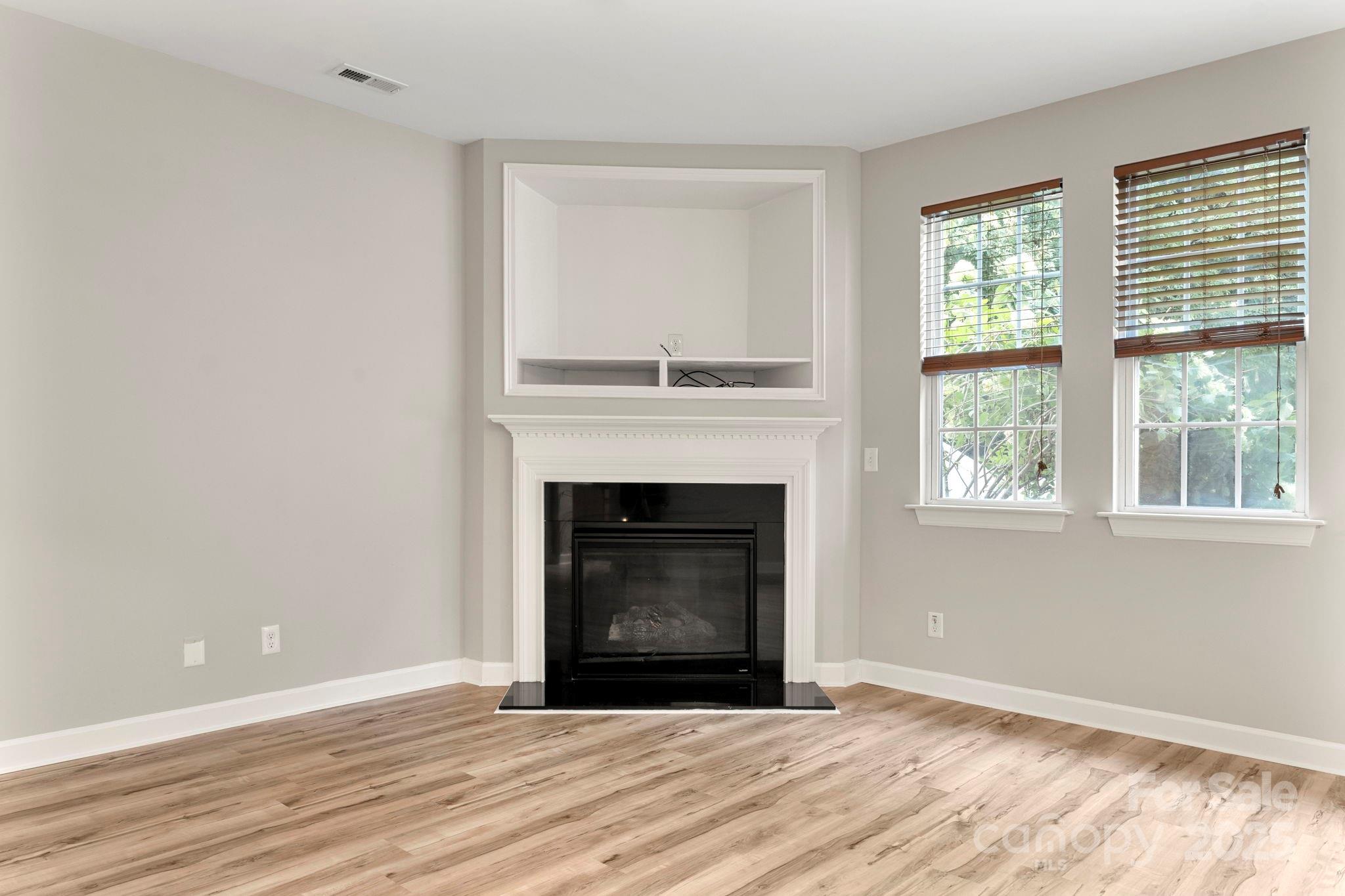 6927 Maricopa Road Charlotte, NC 28277 - Photo 4 of 32 a living room with a fireplace and a fireplace