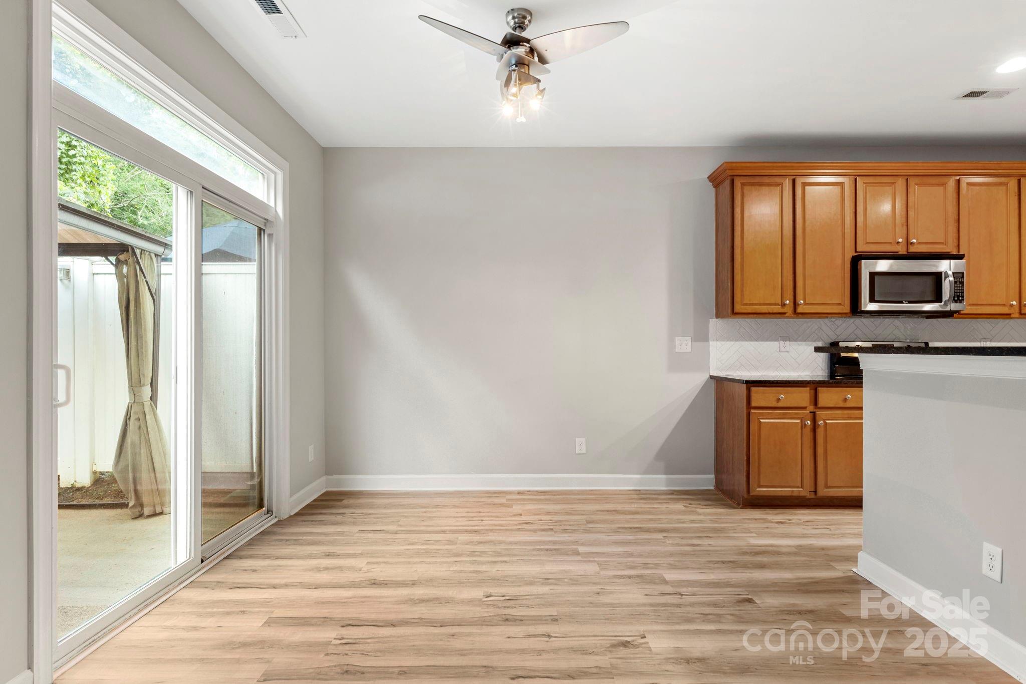 6927 Maricopa Road Charlotte, NC 28277 - Photo 7 of 32 a kitchen with granite countertop a stove a sink and a refrigerator