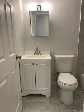 a white toilet sitting next to a bathroom sink