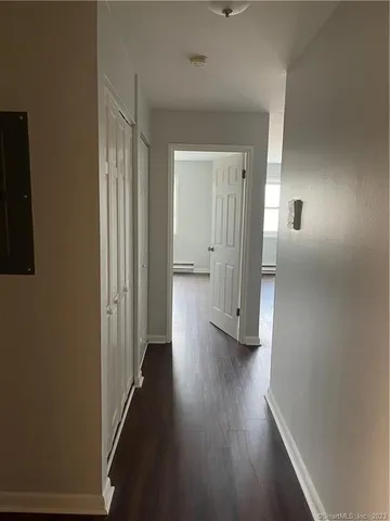 a view of a hallway with wooden floor