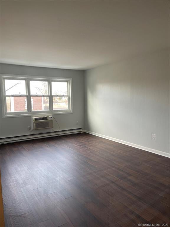 45 Monroe Street, Unit C6 Bridgeport, CT 06605 - Photo 5 of 11 an empty room with wooden floor and windows