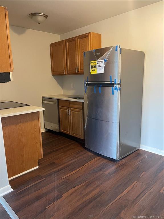 45 Monroe Street, Unit C6 Bridgeport, CT 06605 - Photo 6 of 11 a kitchen with stainless steel appliances a refrigerator sink and wooden floor