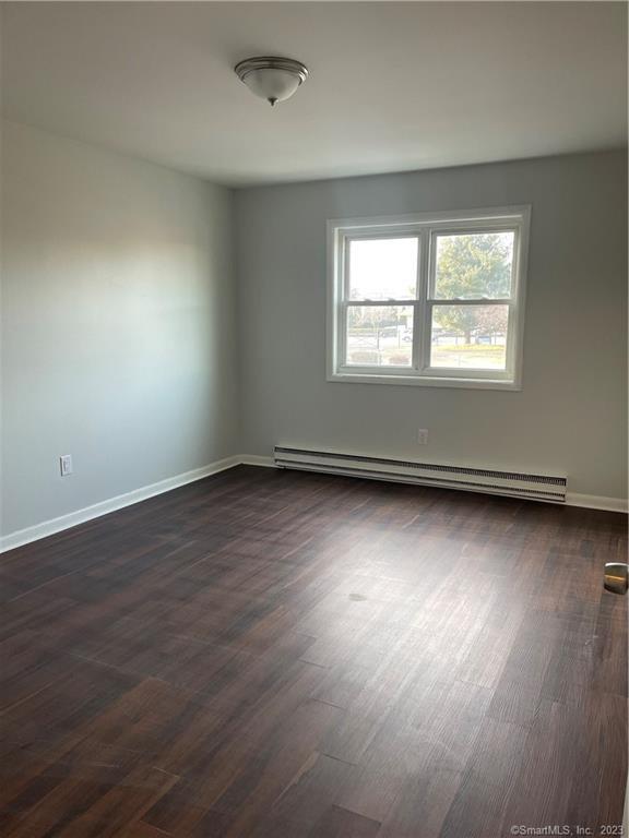 45 Monroe Street, Unit C6 Bridgeport, CT 06605 - Photo 9 of 11 an empty room with wooden floor and windows