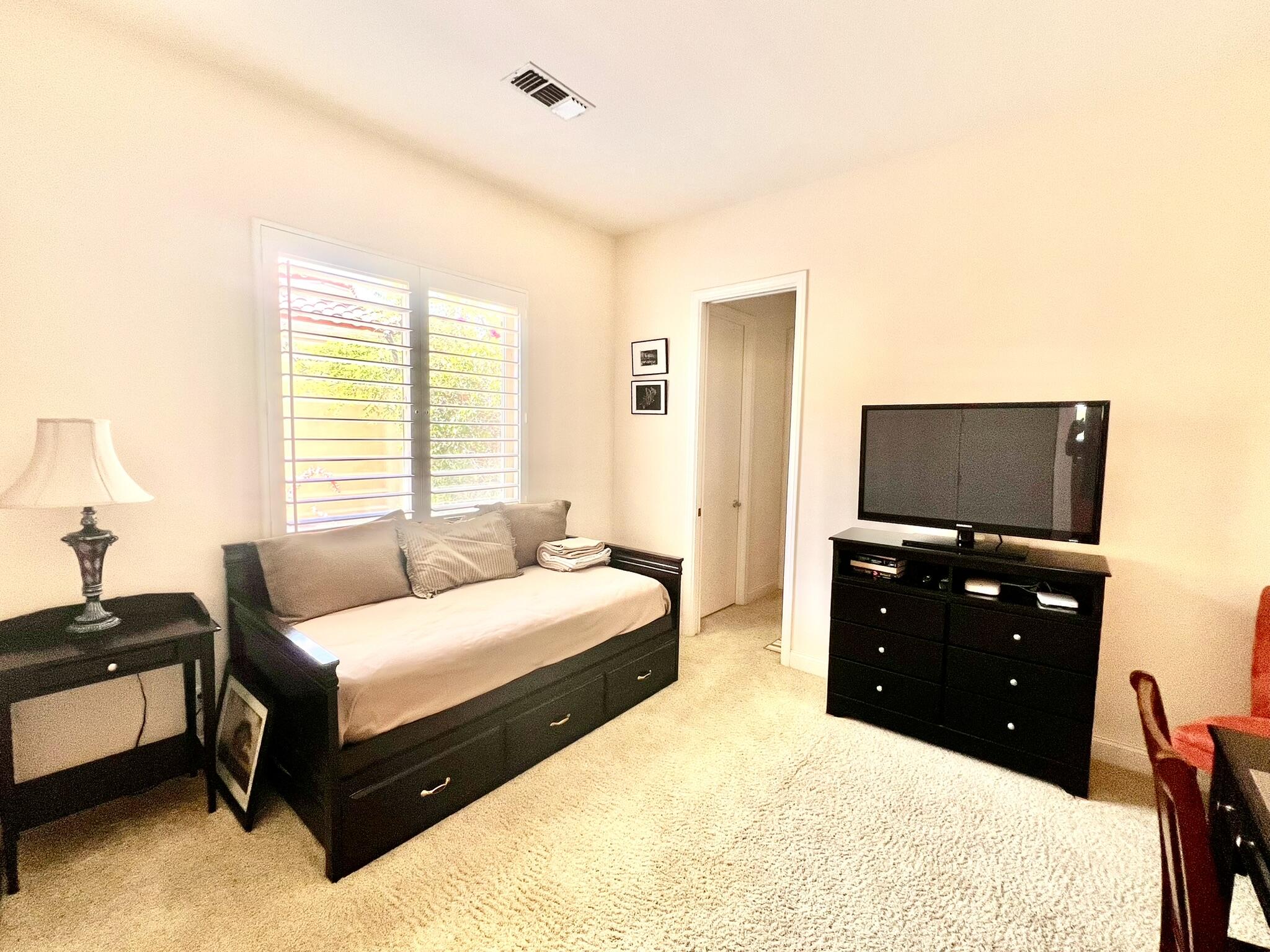 18 Vía Bella Rancho Mirage, CA 92270 - Photo 12 of 15 a bedroom with a bed and a flat screen tv