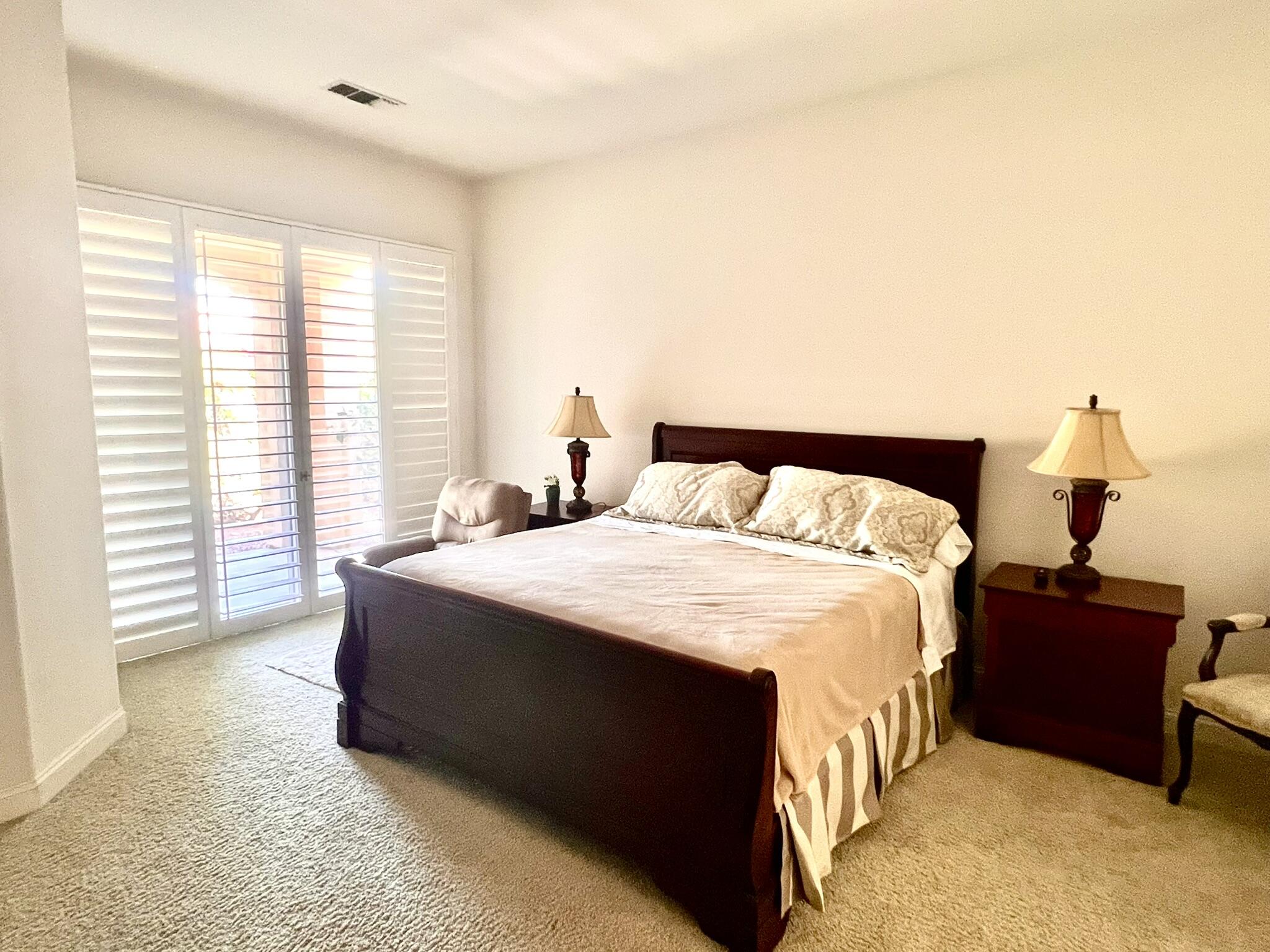 18 Vía Bella Rancho Mirage, CA 92270 - Photo 3 of 15 a bedroom with a bed and a window