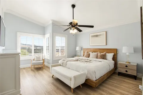 a bedroom with a bed couch and a window