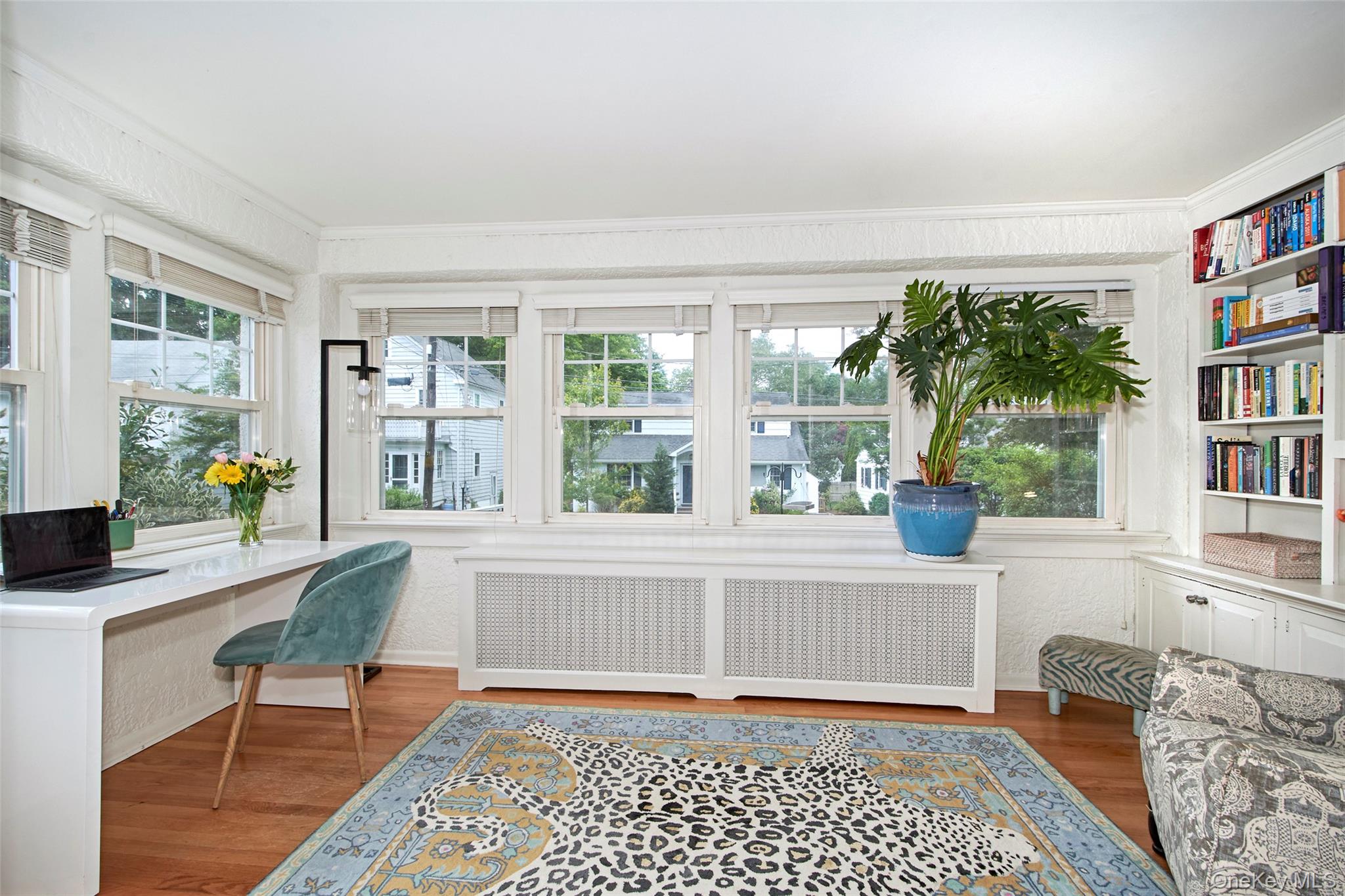 9 Fenton Street Rye, NY 10580 - Photo 7 of 22 Sun-filled flex space featuring built-in shelving, a dedicated workspace, extensive library, comfortable seating, and multiple windows.