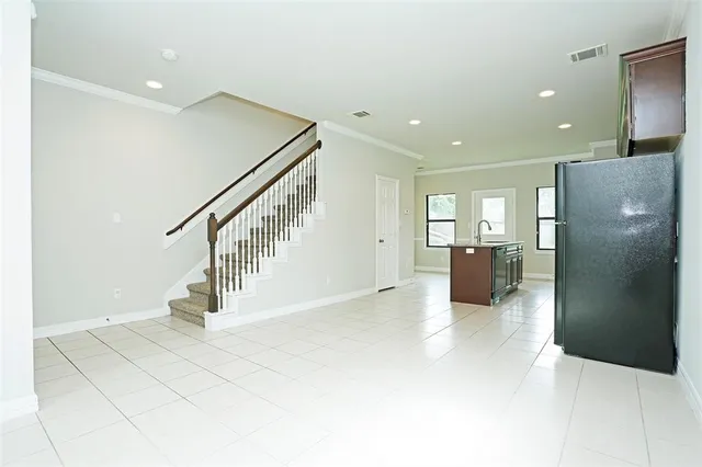 a view of kitchen with furniture and refrigerator