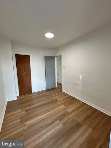 a view of an empty room and wooden floor