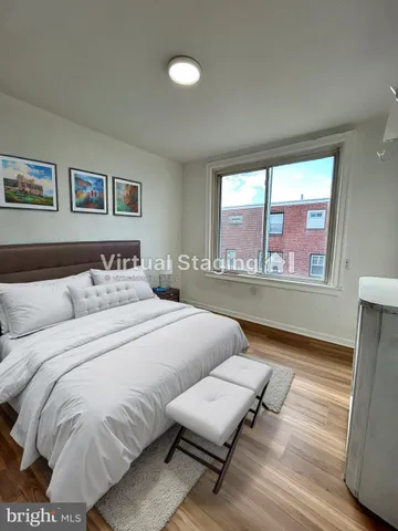 a bedroom with bed and window