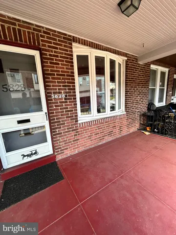 a view of backyard with a car park side of road