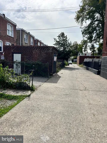 a backyard of a house with lots of green space and fountain
