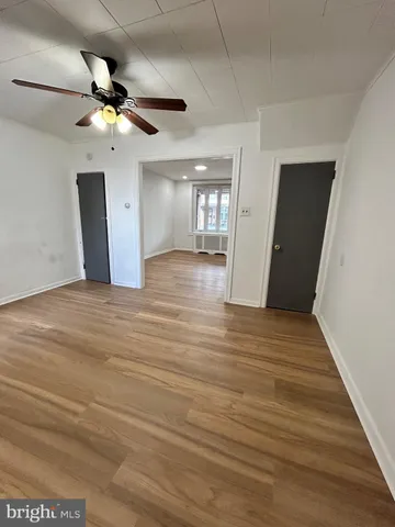 a view of an empty room and wooden floor
