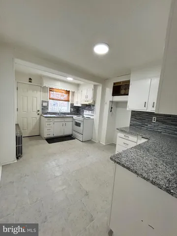 a kitchen with a sink and a stove top oven