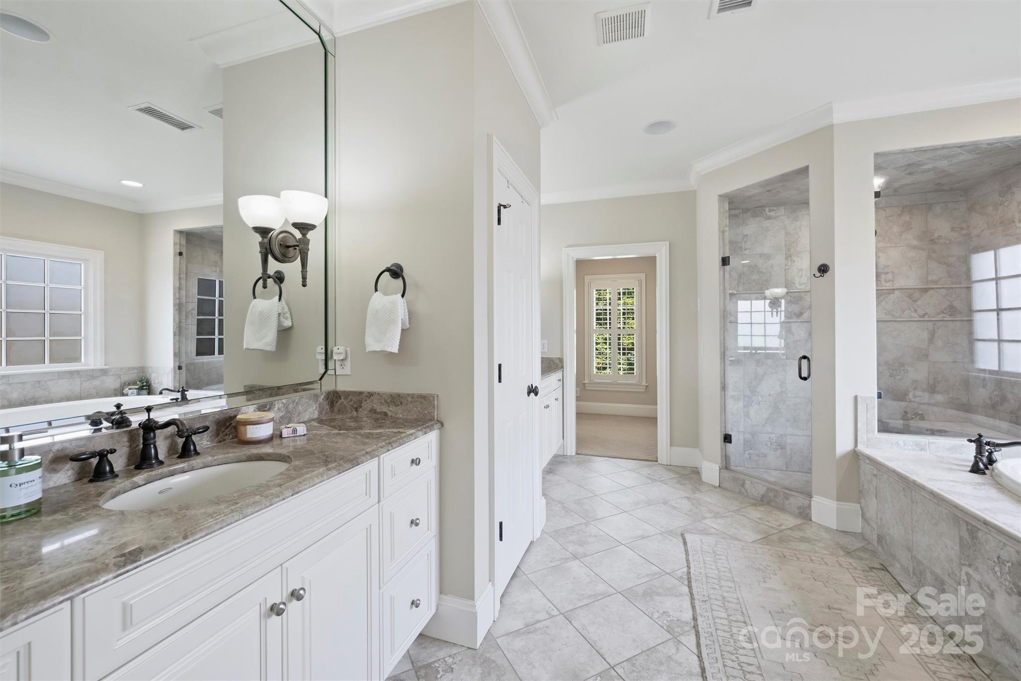 5827 Riley's Ridge Road Charlotte, NC 28226 - Photo 29 of 48 a spacious bathroom with a granite countertop sink mirror and shower