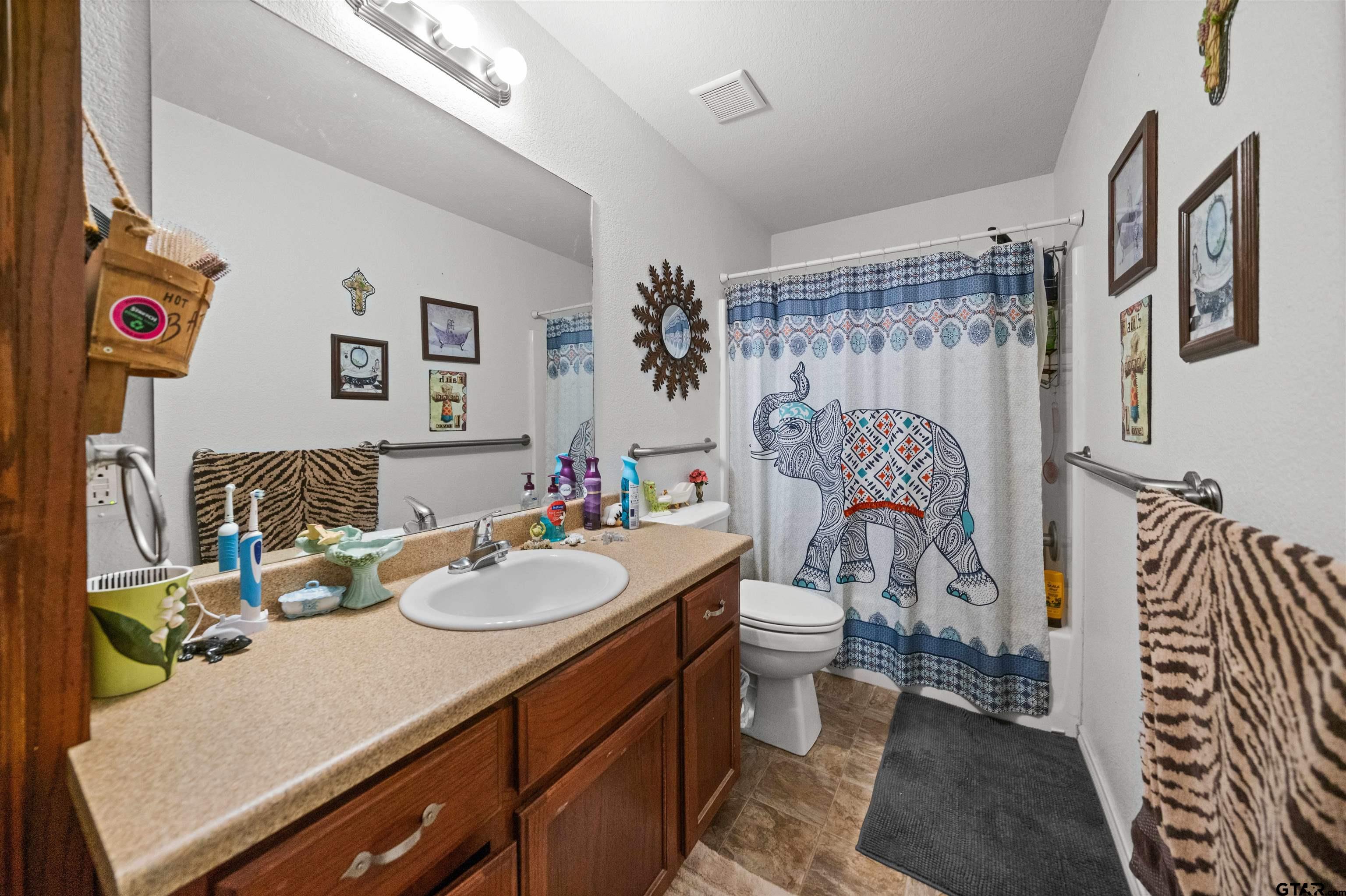 803 Sims Avenue Jacksonville, TX 75766 - Photo 14 of 23 a bathroom with a sink toilet and shower