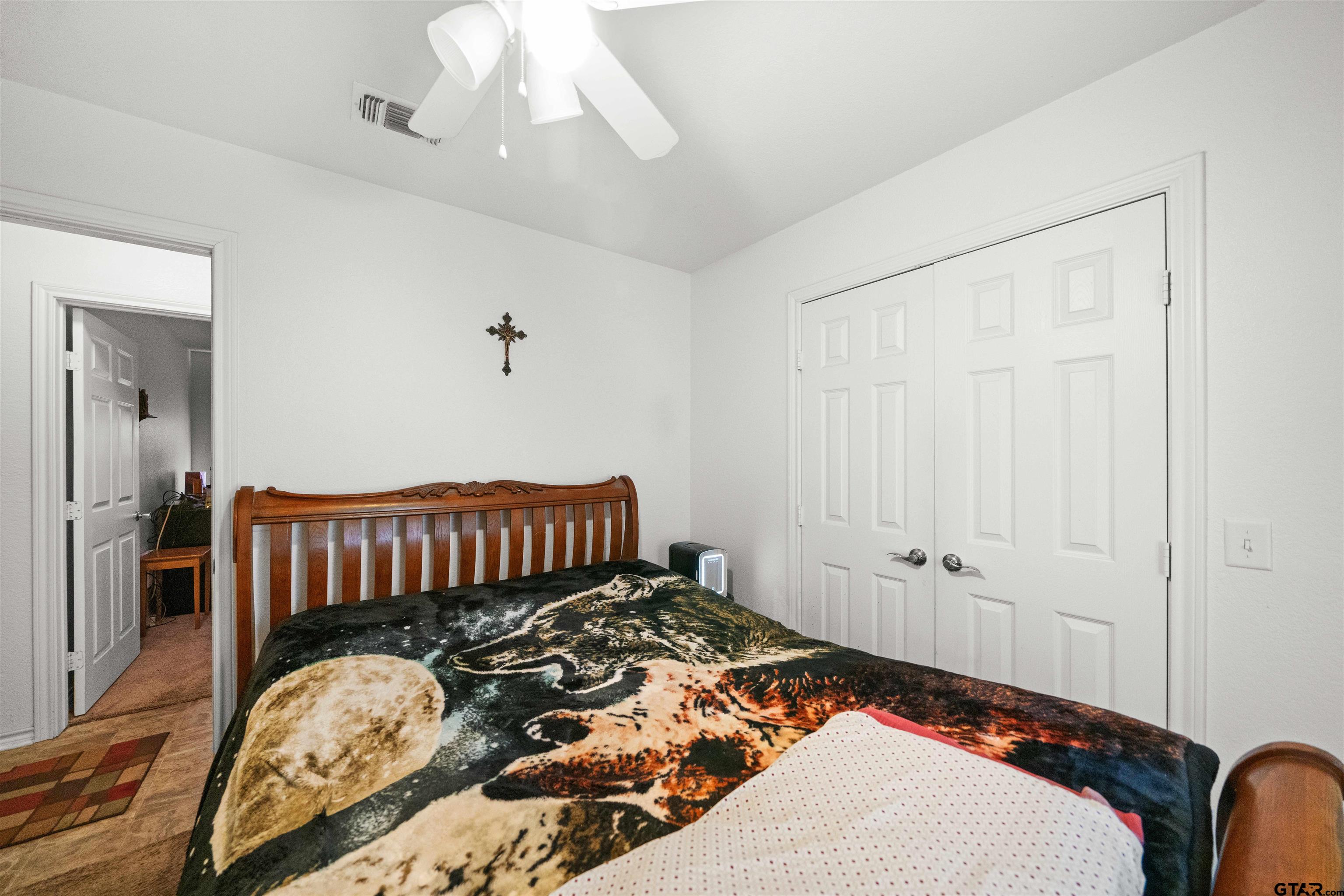 803 Sims Avenue Jacksonville, TX 75766 - Photo 18 of 23 a bedroom with a bed and wooden floor