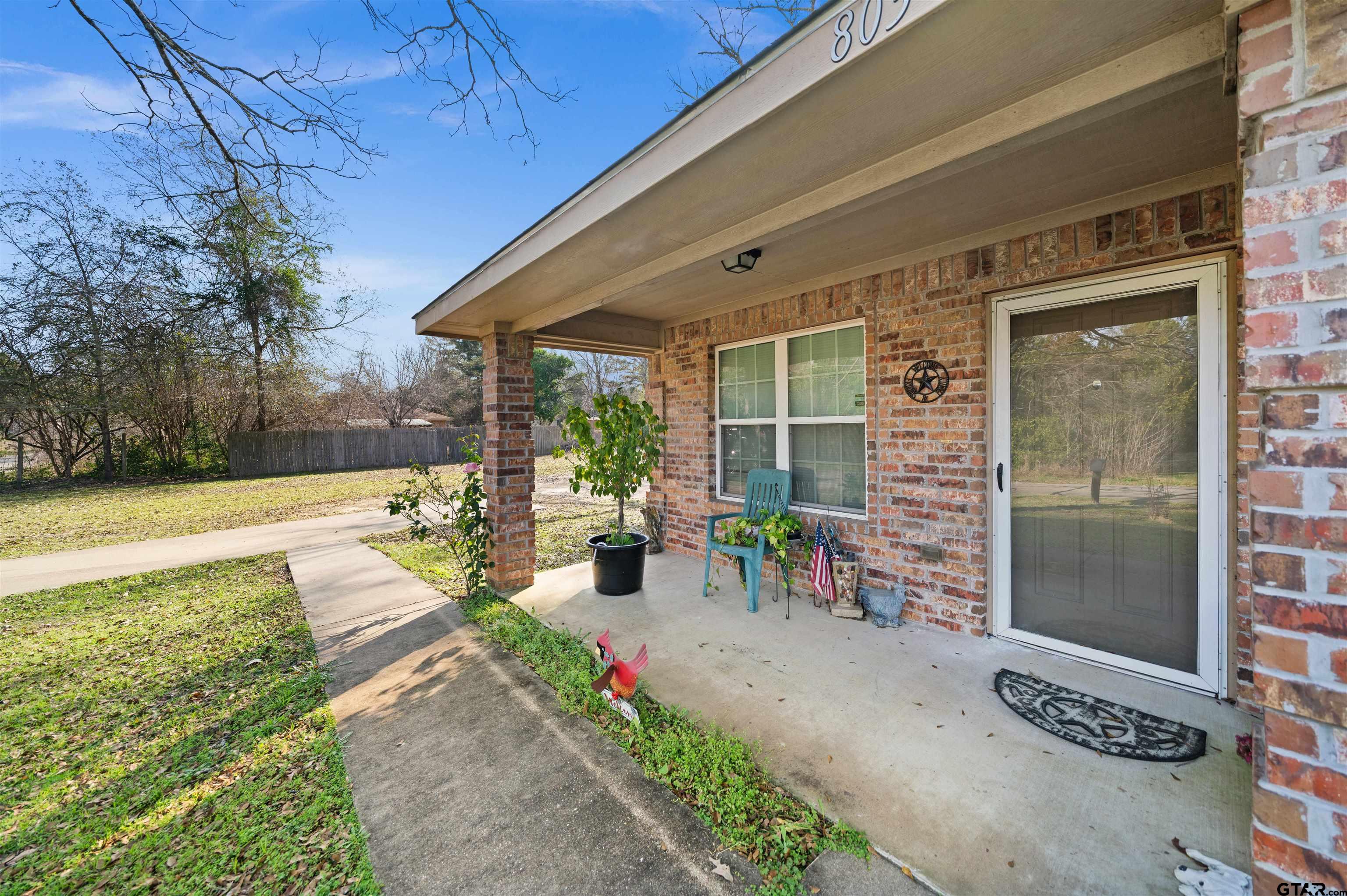 803 Sims Avenue Jacksonville, TX 75766 - Photo 2 of 23 a garden view with a seating space