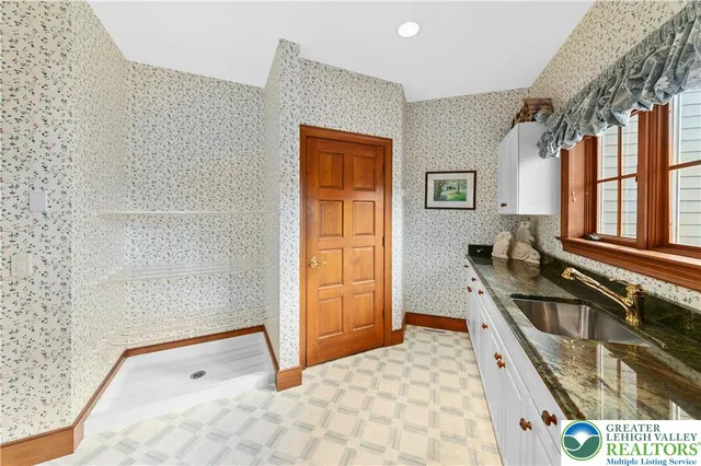 a bathroom with a tub sink and mirror