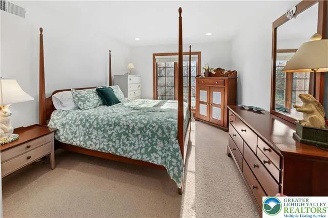 a bed room with a bed window and dresser