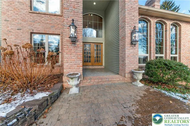 a view of a brick house with large windows