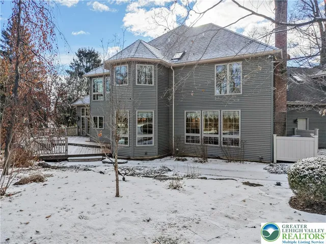 a view of a house with a yard covered in snow