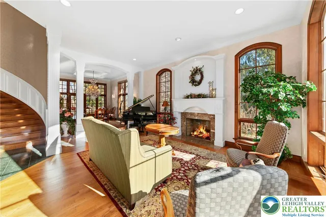 a living room with furniture a fireplace and a potted plant