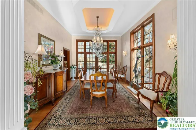 a dining room with furniture a rug and a large window