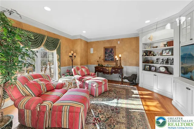 a living room with furniture fireplace and a large window