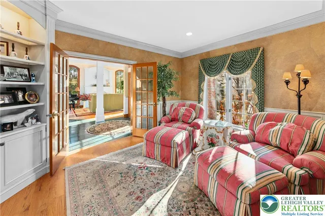 a bedroom with furniture and a large window