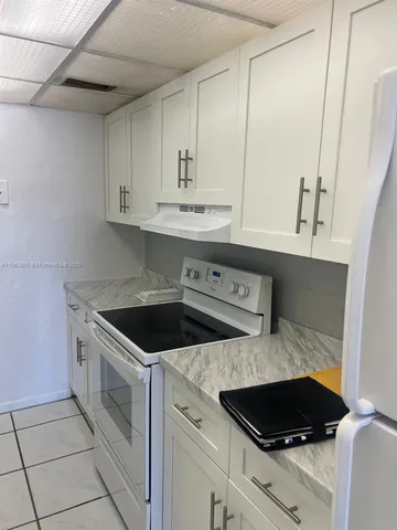 a stove top oven sitting inside of a kitchen