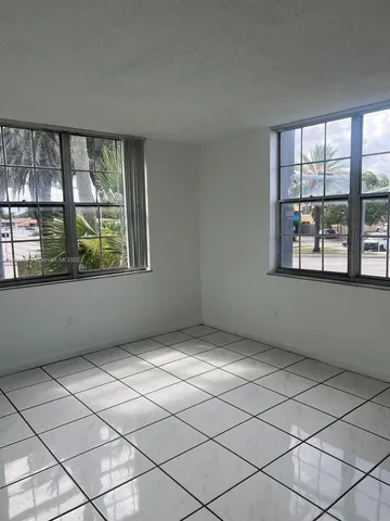 a view of an empty room with a window