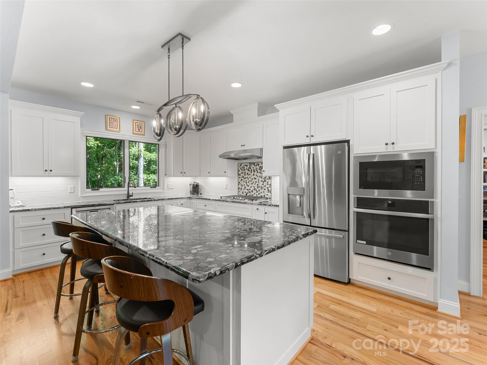 249 Tsisqua Circle Brevard, NC 28712 - Photo 16 of 39 a kitchen with stainless steel appliances granite countertop a sink a stove and a refrigerator