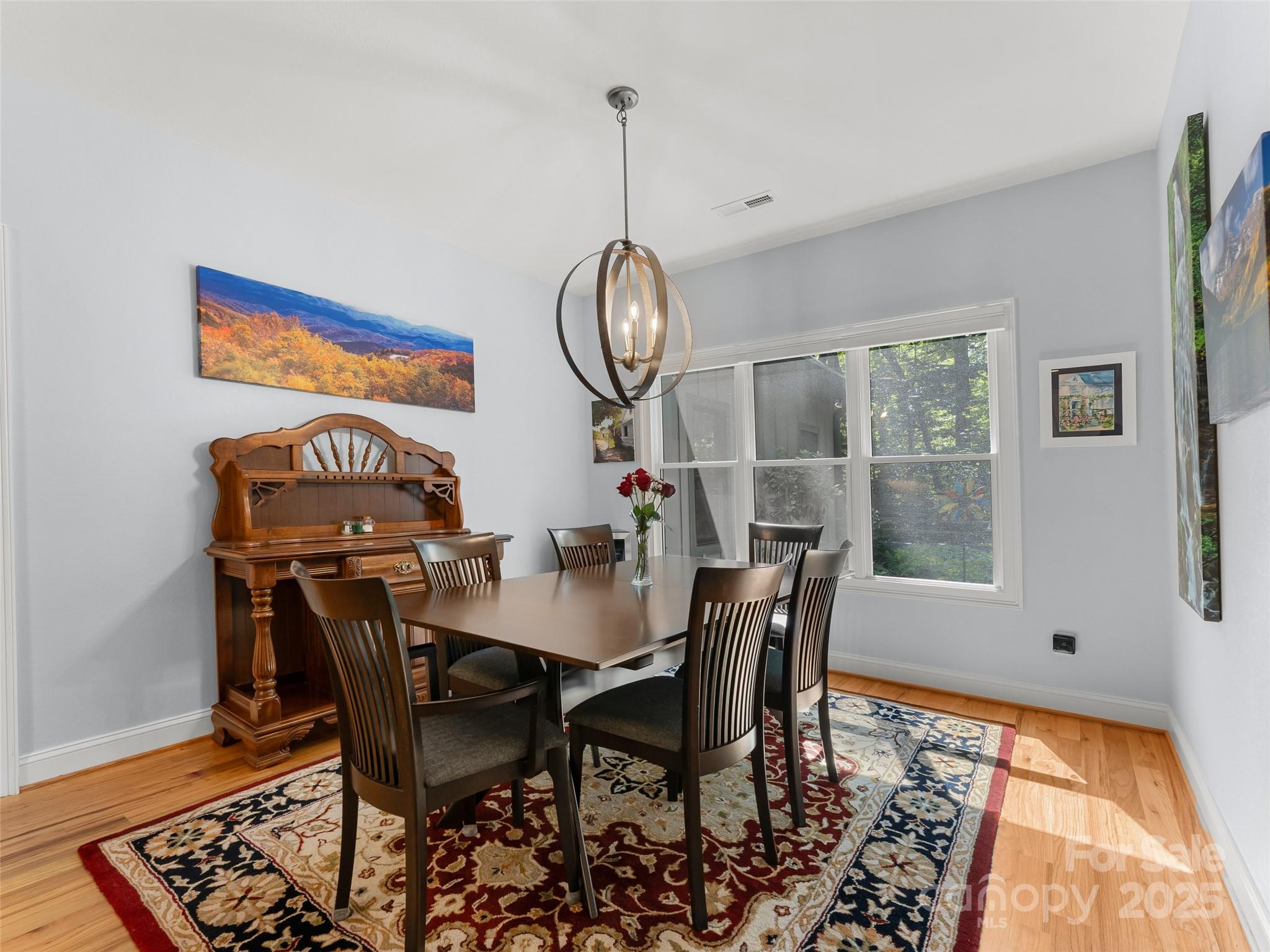 249 Tsisqua Circle Brevard, NC 28712 - Photo 20 of 39 a view of a dining room with furniture window and wooden floor