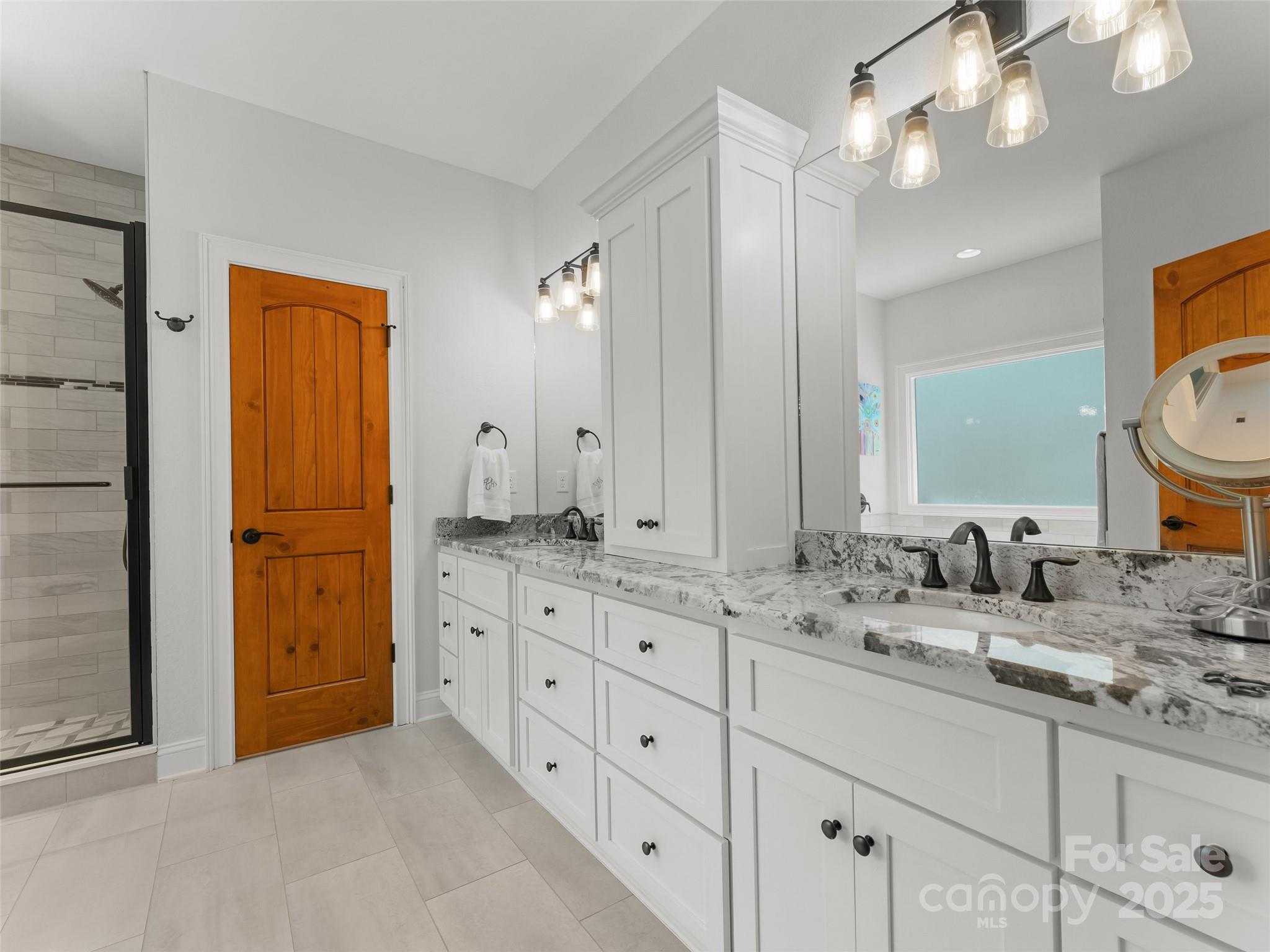 249 Tsisqua Circle Brevard, NC 28712 - Photo 28 of 39 a bathroom with a granite countertop double vanity sink mirror and shower