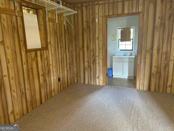a view of a closet with wooden floor