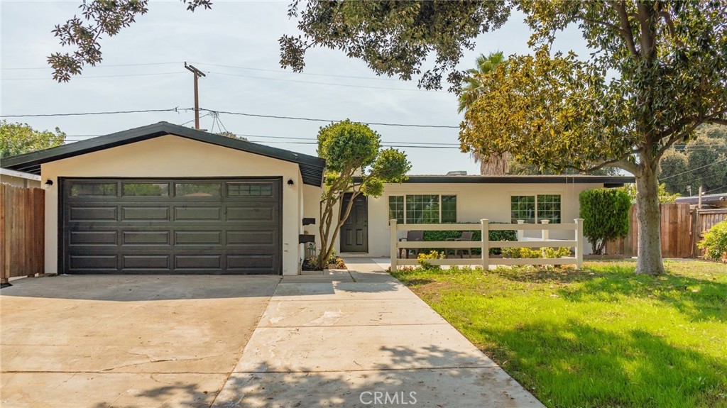 3056 Gertrude Street Riverside, CA 92506 - Photo 1 of 1 a front view of a house with a yard and garage
