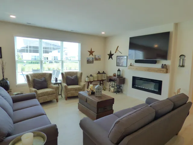 a living room with furniture flat screen tv and a fireplace